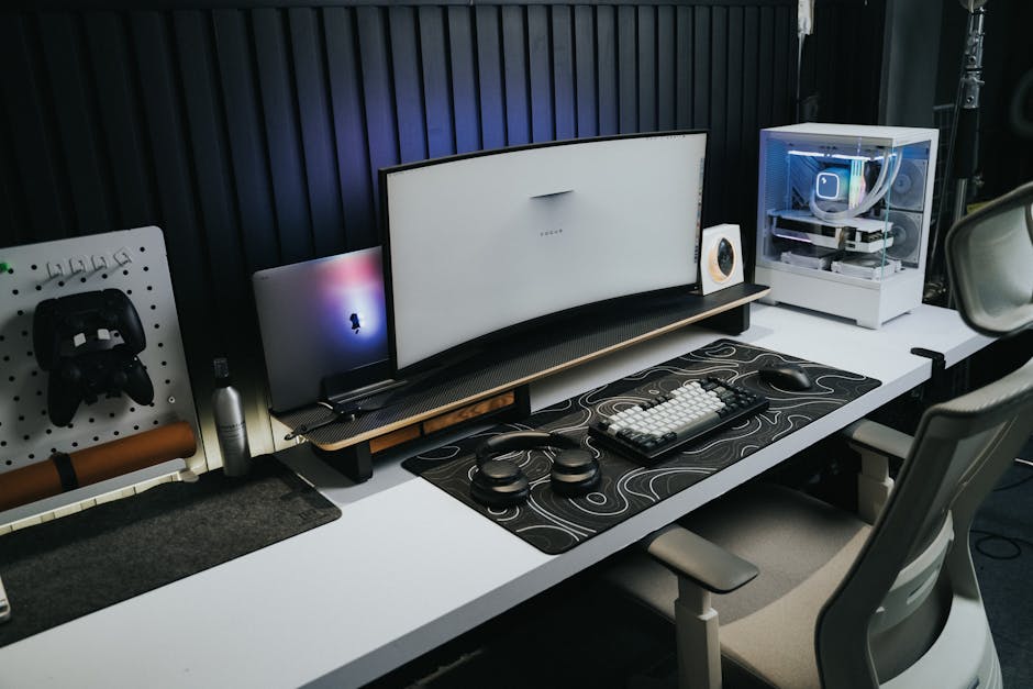 A sleek, modern office setup with a gaming PC, curved monitor, and accessories.